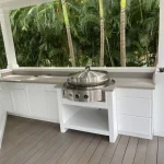 outdoor kitchen with palm trees in background