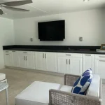 outdoor kitchen cabinetry with tv mounted above
