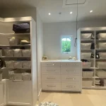 Her closet semi-custom cabinetry